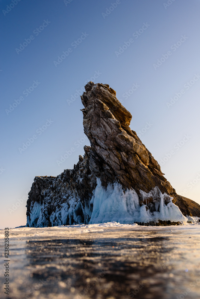 rock in Siberia on a sunny day the ice of Lake Baikal on Olkhon Island