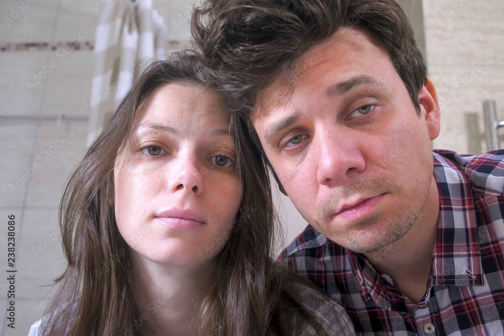 Sleepy couple man and woman in the bathroom with hangover trying to Wake up. Sleepy couple man and woman in the bathroom with hangover trying to Wake up.