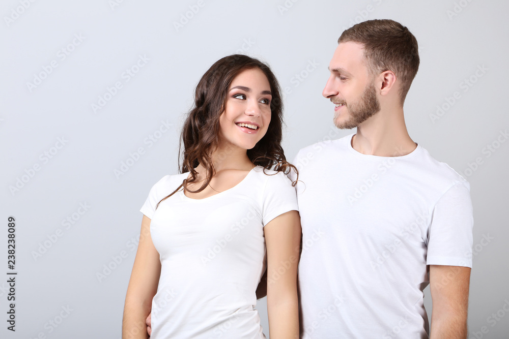 Happy young couple on grey background Happy young couple on grey background