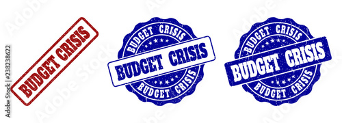 BUDGET CRISIS grunge stamp seals in red and blue colors. Vector BUDGET CRISIS signs with draft surface. Graphic elements are rounded rectangles, rosettes, circles and text labels.