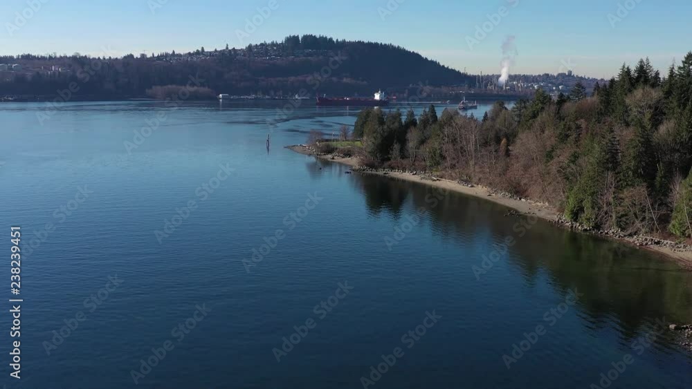 Aerial view over Burrard Inlet, ocean and island with boat and mountains in beautiful British Columbia. Canada. Aerial view over Burrard Inlet, ocean and island with boat and mountains in beautiful British Columbia. Canada.