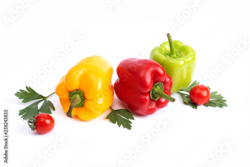 Red and green sweet peppers on a white background...