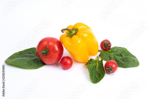 Yellow sweet pepper and tomatoes on a white background.