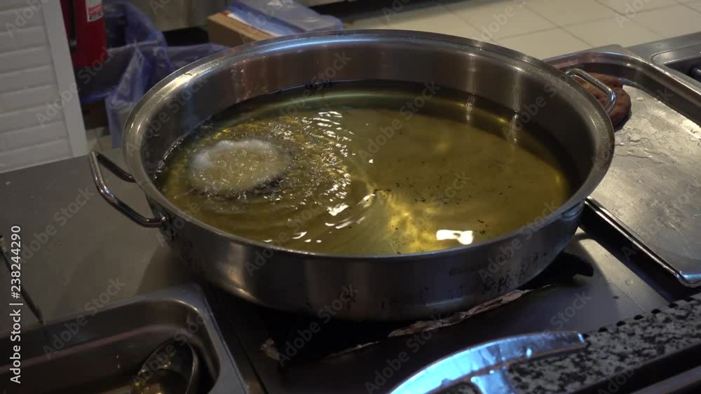 Chief makes donuts. Donuts fry in boiling oil. Chief makes donuts. Donuts fry in boiling oil.
