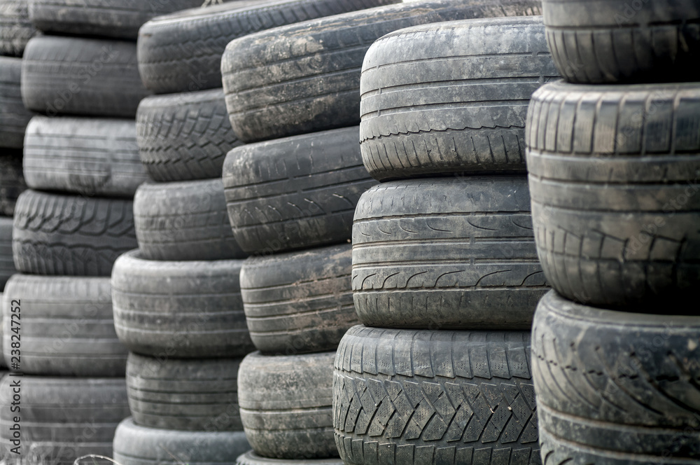 Used wheel tires stacked ready for recycling. Used wheel tires stacked ready for recycling.