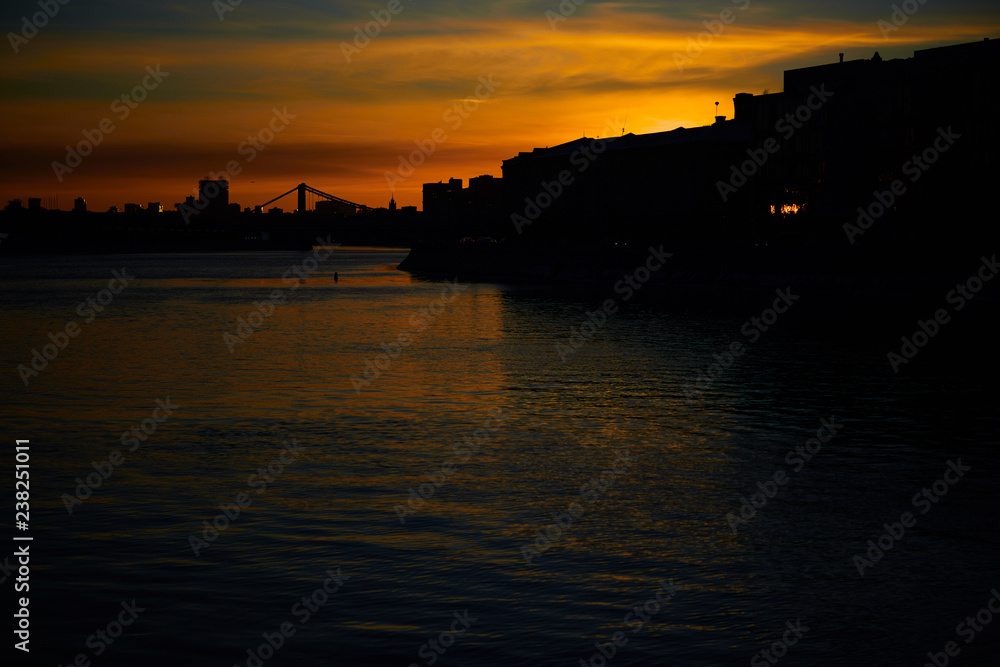 Dark cityscape with sunset over the Moscow river