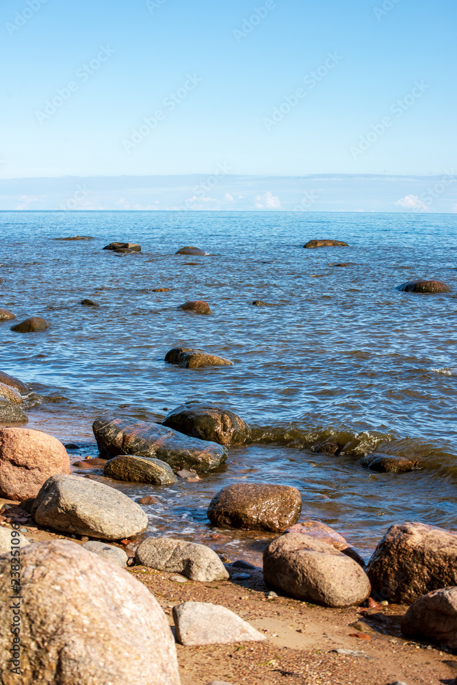 rock covered beach in countryside in Latvia, large rocks in water rock covered beach in countryside in Latvia, large rocks in water