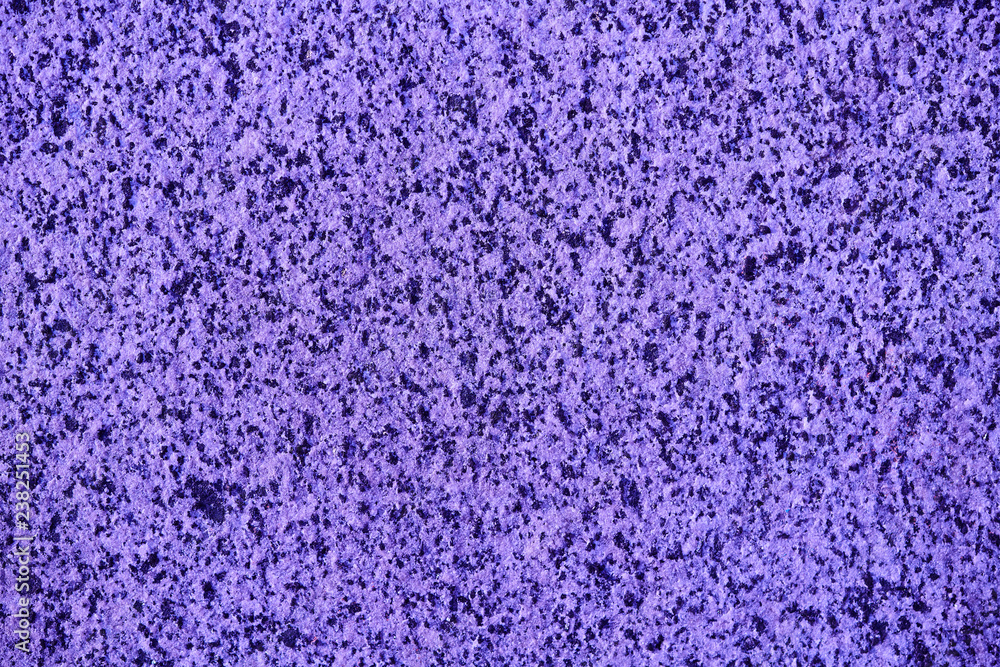 The textured ultraviolet or magenta marble chips wall, background