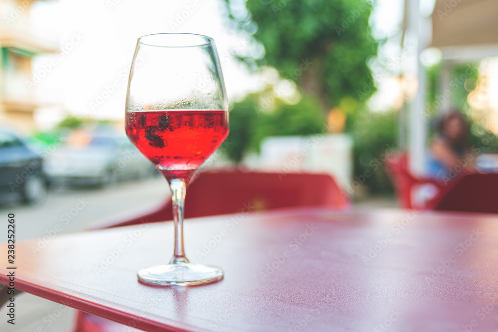 Glass of rose wine on the table in street cafe Vintage toning Selective focus Copy space Glass of rose wine on the table in street cafe Vintage toning Selective focus Copy space