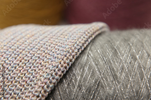 Background of bobbin with yarn and knitted fabric.