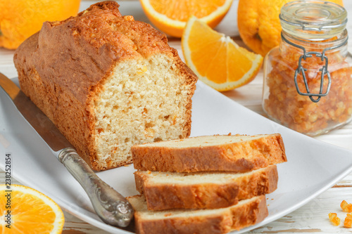 Homemade orange fruit loaf cake with citrus candied fruits and nuts.  Traditional treat for tea for Breakfast. Pound cake. Selective focus photo