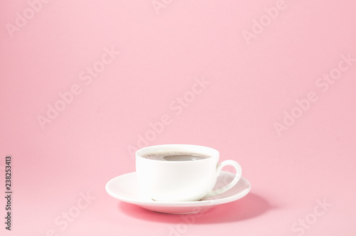 white cup with a saucer on a pink background white cup with a saucer on a pink background  selective focus