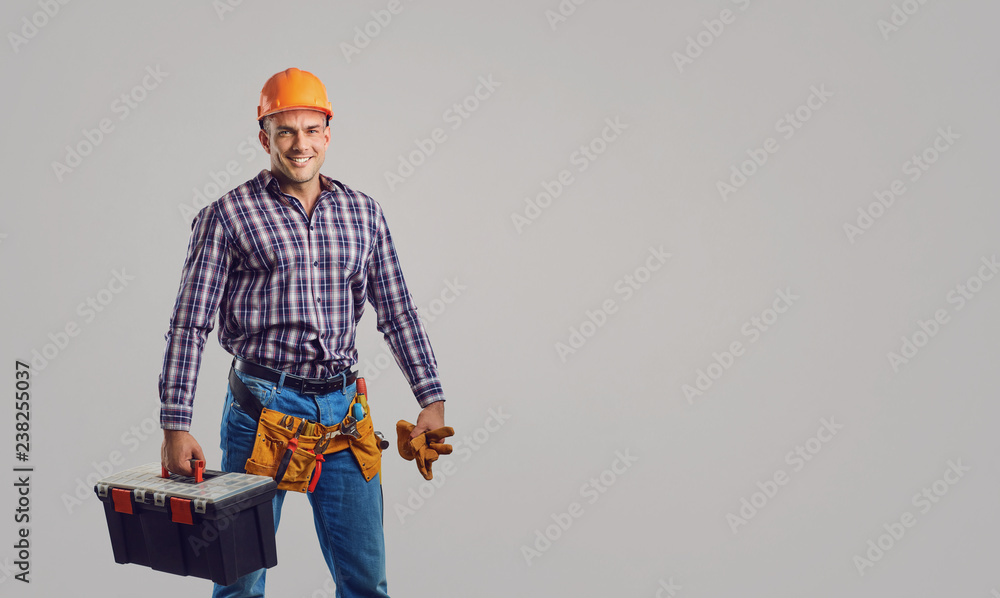 Repairman smiling in special clothes with tools. Repairman smiling in special clothes with tools.