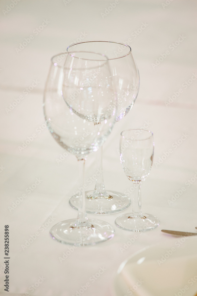 Empty glass on a white wedding table. Empty glass on a white wedding table.