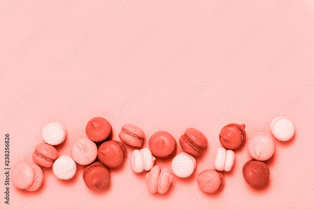 Group of sweet mini macarons colored in Living Coral trendy color. Creative concept of color of the year 2019. Top view, flat lay. Group of sweet mini macarons colored in Living Coral trendy color. Creative concept of color of the year 2019. Top view, flat lay.