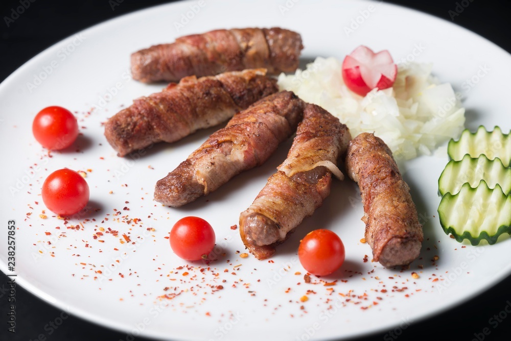 white plate with kebabs isolated on dark background. kebab isolated white plate with kebabs isolated on dark background. kebab isolated