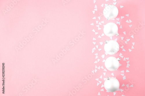 Christmas elegant modern composition. Frame made of white balls and decorations on pastel pink background. Christmas, New Year, winter concept. Flat lay, top view, copy space