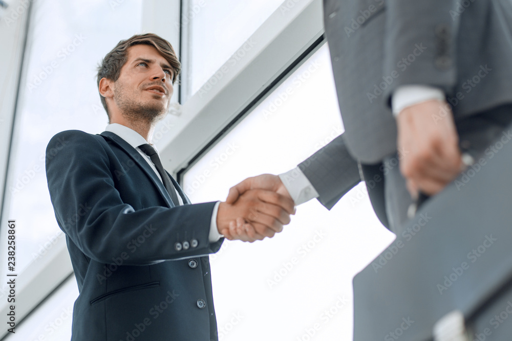 bottom view. handshake business partners in the office bottom view. handshake business partners in the office