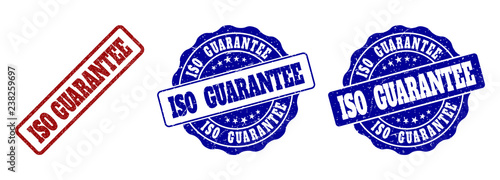 ISO GUARANTEE grunge stamp seals in red and blue colors. Vector ISO GUARANTEE labels with scratced effect. Graphic elements are rounded rectangles, rosettes, circles and text labels.