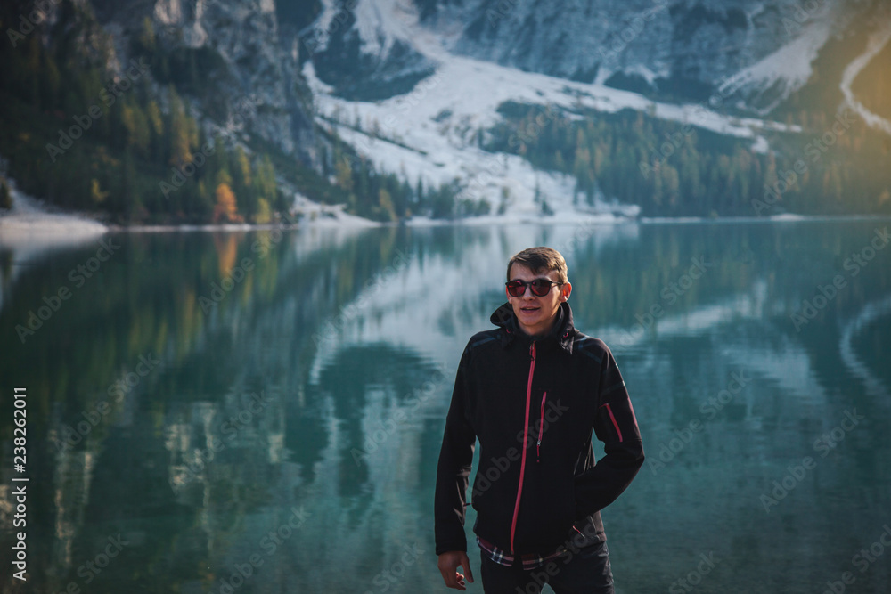 Man Standing on Rock at Beautiful Alpine Lake