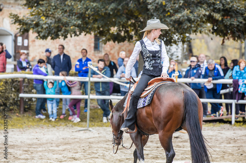 Cowgirl riding horse backwards photo