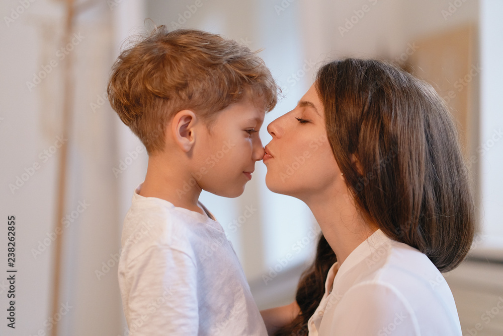 Smiling young mother kiss her preschool son nose. Stock Photo Adobe Stock