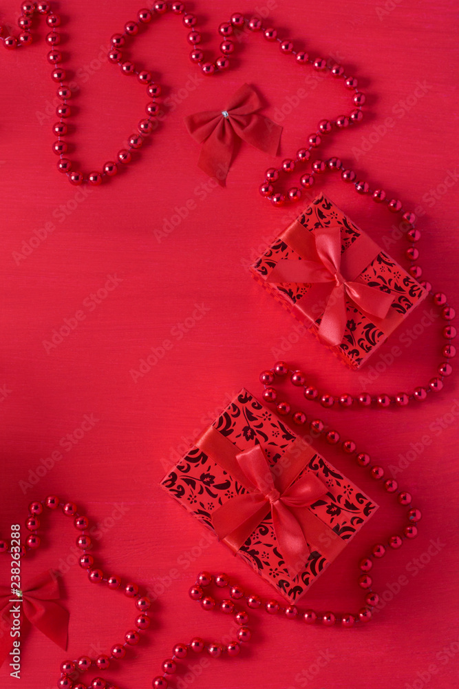 Obraz premium Christmas decor gift boxes bows beads red colors wooden background