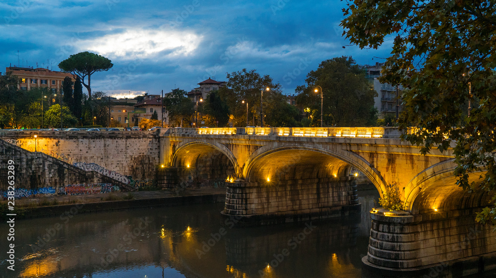 Rome, Lazio, Italy. Night view of the city, Tiber river and Ponte Regina Margherita bridge Rome, Lazio, Italy. Night view of the city, Tiber river and Ponte Regina Margherita bridge