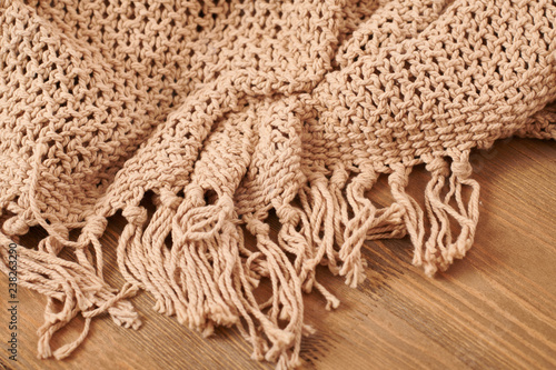 brown knitted blanket on wooden background