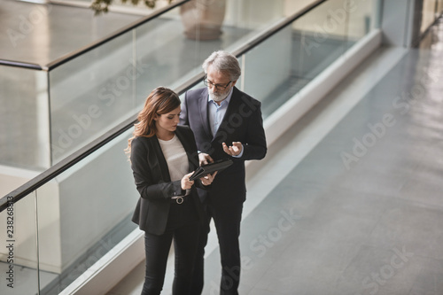 A couple of bussinessmen and bussines woman discussing an important topic