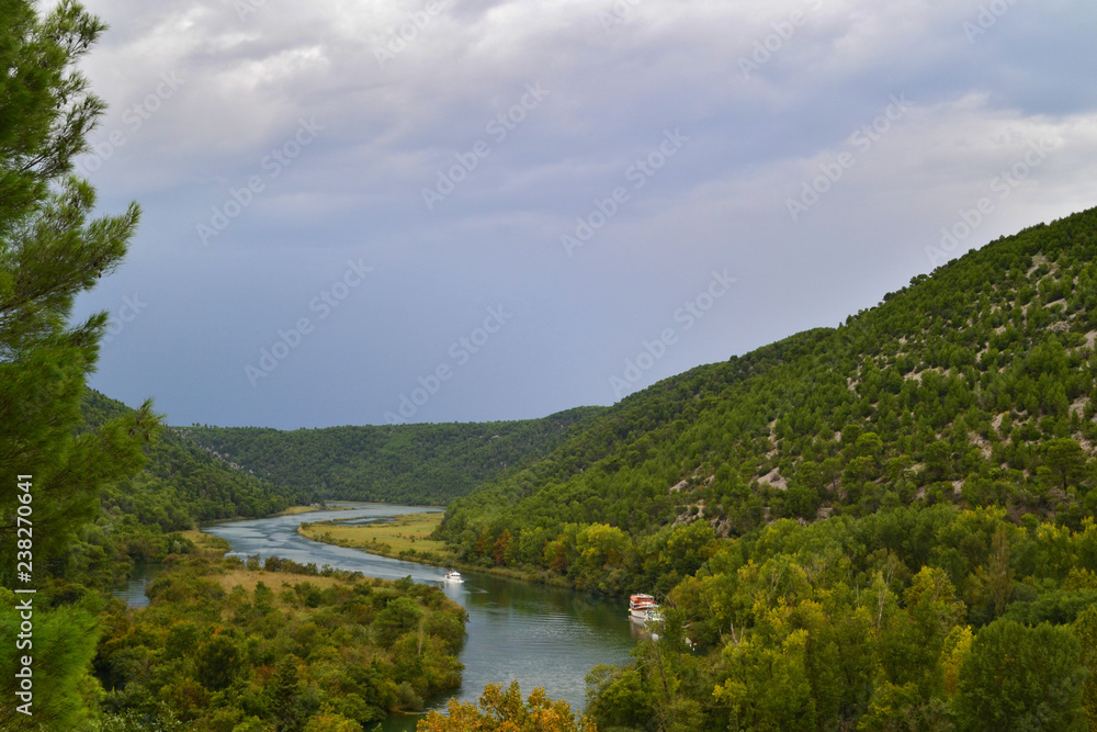 Fototapeta Panorama on the river Krka and singhtseeing boats the national Park Krka. Summer, cloudy day. Croatia.