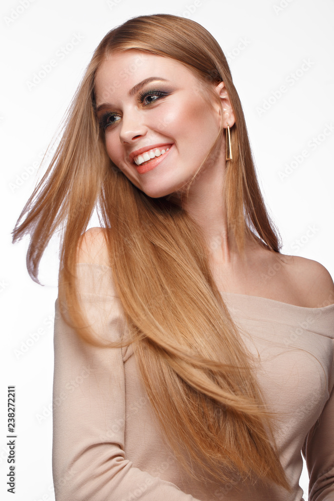 Beautiful blond girl with a perfectly smooth hair, classic make-up. Beauty face Beautiful blond girl with a perfectly smooth hair, classic make-up. Beauty face