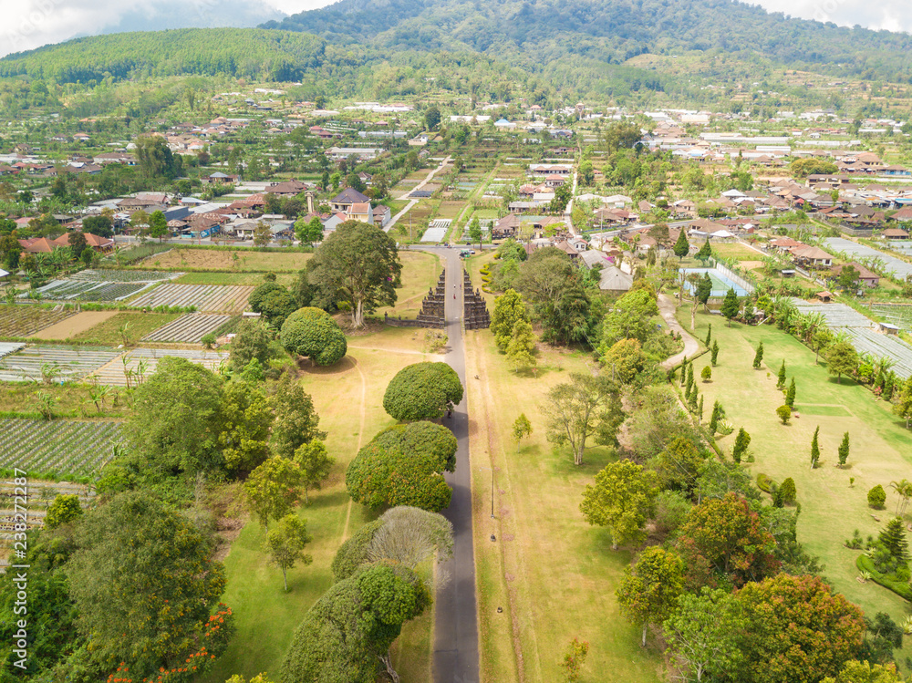 Obraz premium Aerial view of Ancient Bali gate with pathway in Bedugul village. North of Bali island, Indonesia