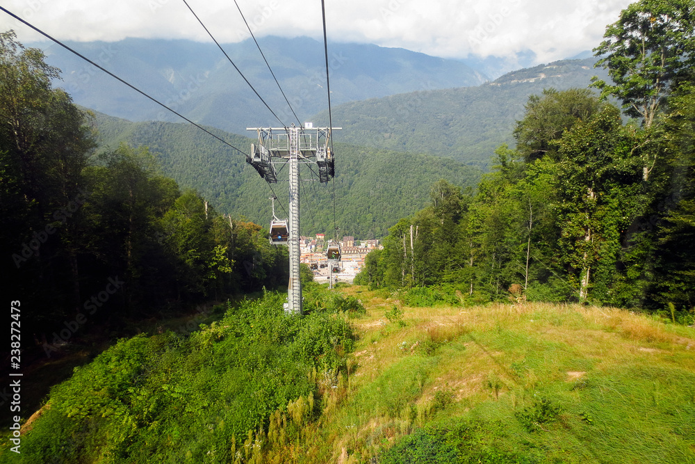 Cable car overlooking the edge of the forest and green trees Cable car overlooking the edge of the forest and green trees