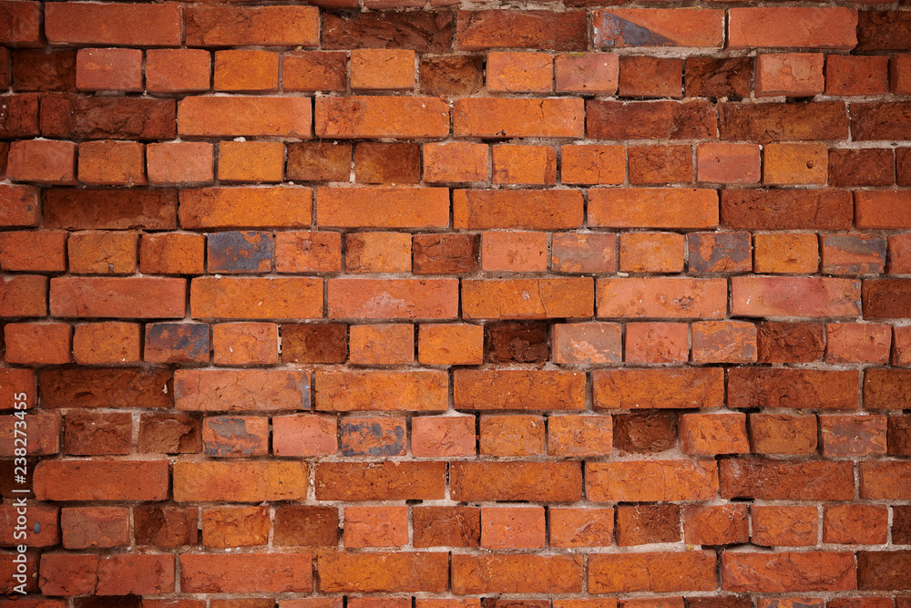 Obraz premium The texture of an old wheatered red brick wall, background