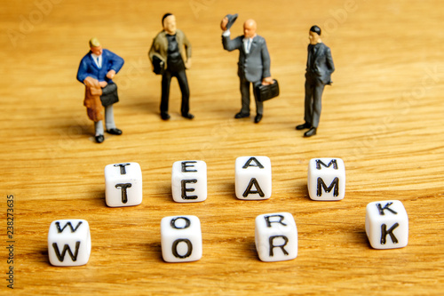 little miniature figurines with little dices forming word team work as a part of team meeting collection pictures