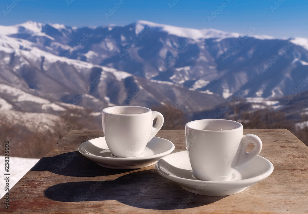 coffee cups on mountain top ,snow. ski