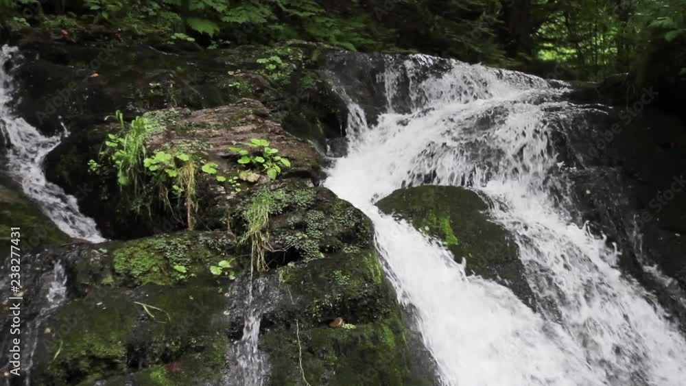 Strong water flow running over the rocks. Forming waterfall, natural wonder, enjoying the landscape Strong water flow running over the rocks. Forming waterfall, natural wonder, enjoying the landscape