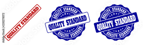 QUALITY STANDARD scratched stamp seals in red and blue colors. Vector QUALITY STANDARD signs with grunge effect. Graphic elements are rounded rectangles, rosettes, circles and text tags.