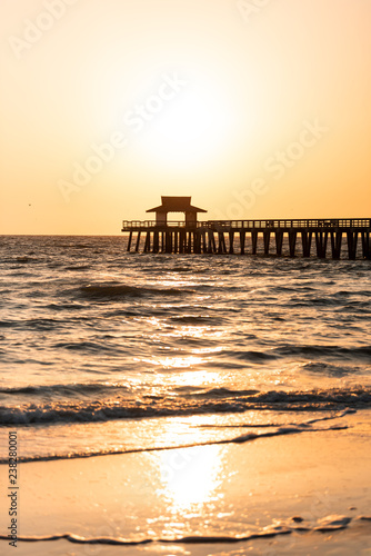 Obraz na plátně Naples, Florida yellow and orange sunset in gulf of Mexico with sun setting by P