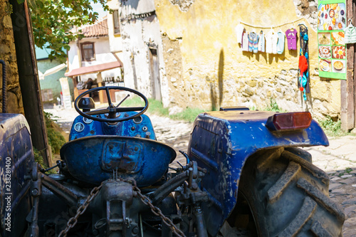 Blue tractor on a narrow streen in Cumalikizik, Bursa, Turkey photo