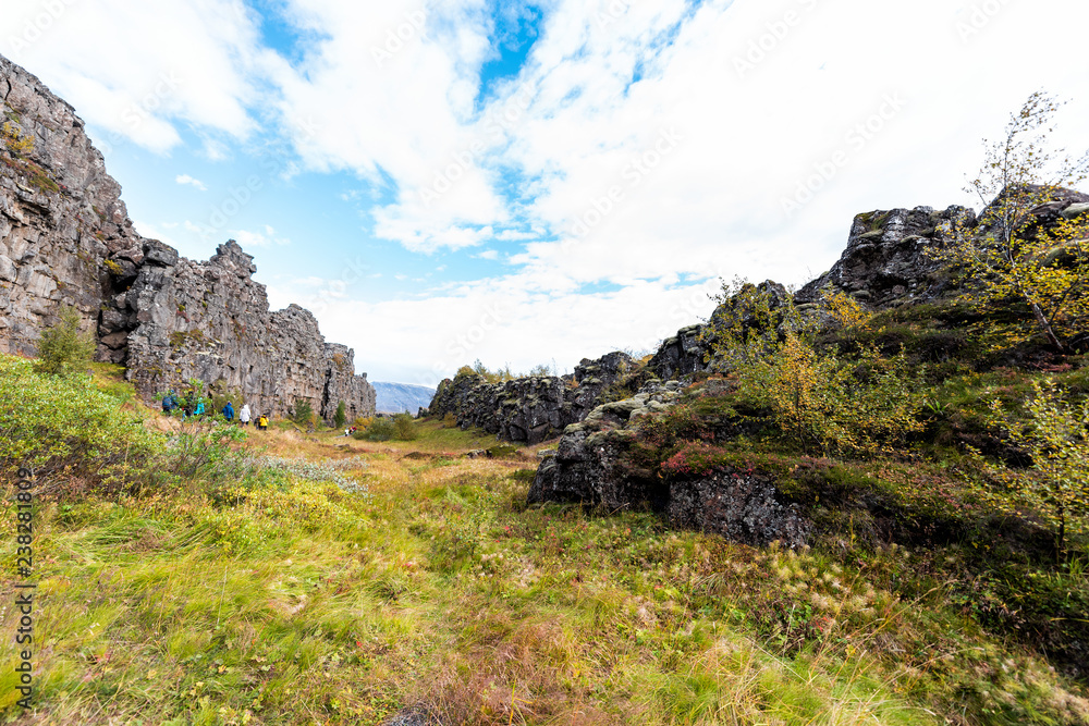 Thingvellir National Park grass autumn plants during day landscape, people walking on canyon trail in Iceland, Golden circle route Thingvellir National Park grass autumn plants during day landscape, people walking on canyon trail in Iceland, Golden circle route