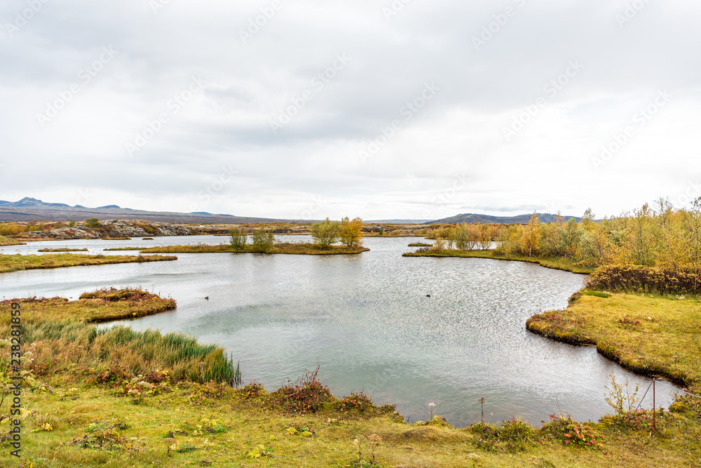 Thingvellir National Park river water lake pond, lagoon landscape on Golden Circle in South Iceland, cloudy day, ripples wind, nobody at Golden circle route