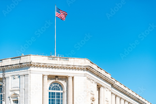 Washington DC, USA US Congress on Capital capitol hill, Russell Senate Office building exterior with waving American Flag on pole against blue sky