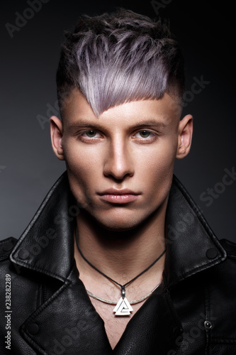 Obraz na plátně Young man with purple hair and creative makeup and hair.