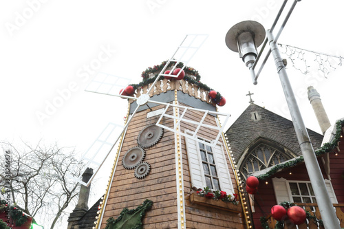 A mill stand at the Christmas Markets in the pedestrian Working Street next to Saint John the Baptist Church in Cardiff, United Kingdom