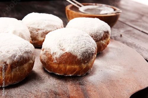 German donuts with jam and icing sugar. Carnival powdered sugar raised donuts