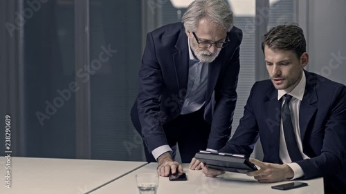 A couple of bussinessmen and bussines woman discussing an important topic