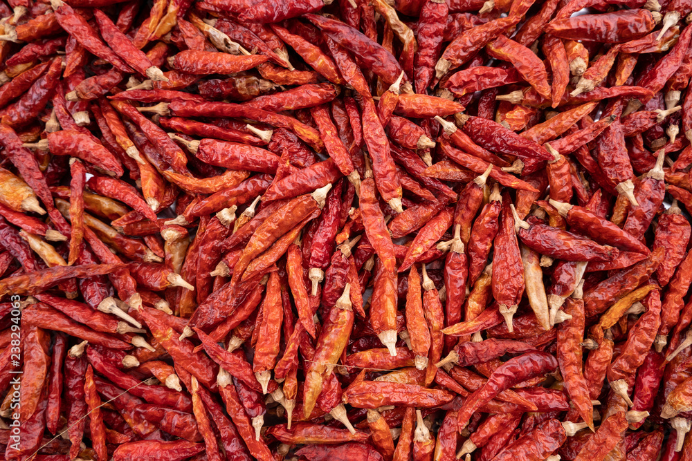 Fototapeta premium Pile of dried red chili peppers background, food ingredient, top view .