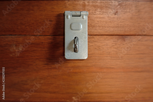 Close up of Metal Hasp staple on wooden box, Key Locking Devices to secure storage.